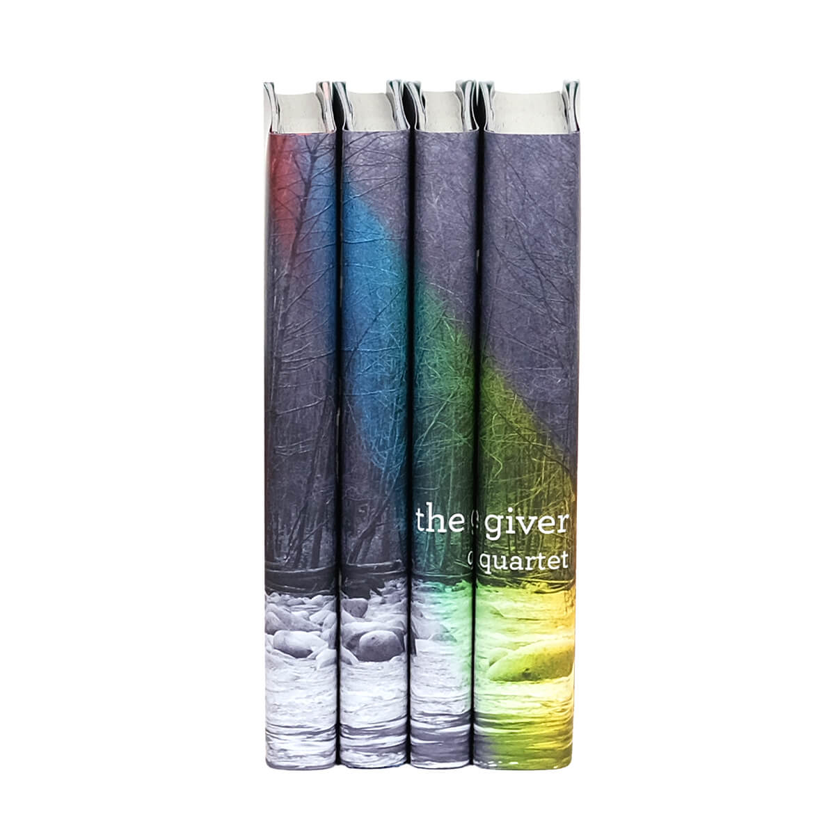 The Giver Quartet custom collectible dust jackets by Juniper Custom. Photo of woods and a river in black and white with a rainbow stretching across spines. The Giver typed across spines in simple white serif font.