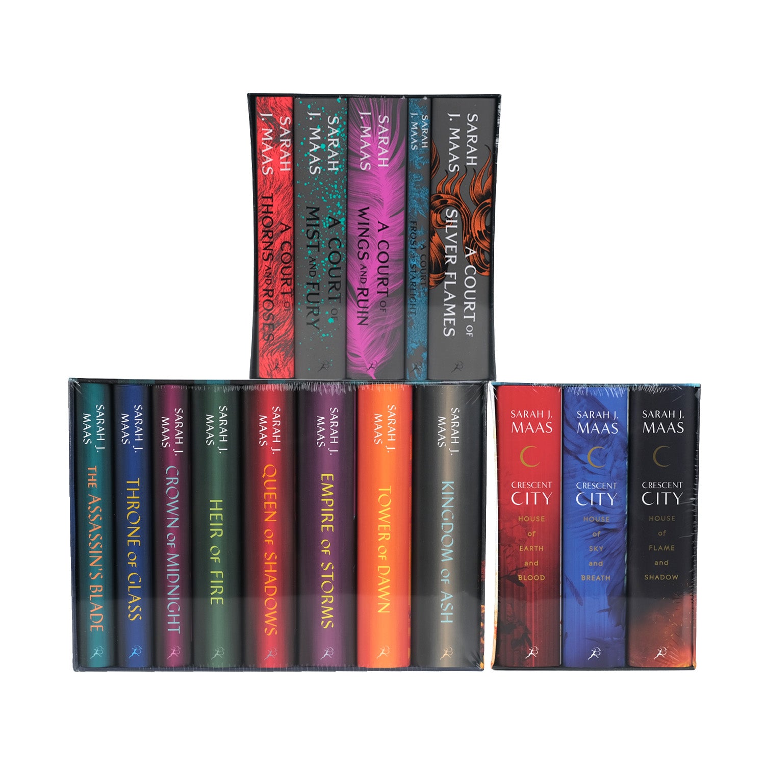 Sarah J Maas' three book series: A Court of Thorns and Roses, Throne of Glass, and Crescent City sitting in a tiered stack in their publisher jackets and shrink wrapped in their publisher boxes.