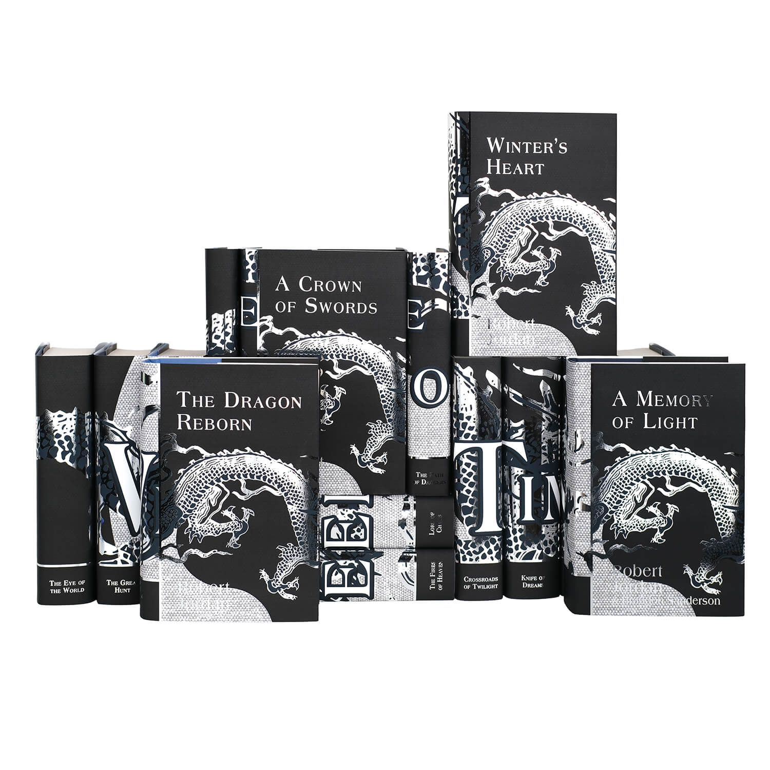 Front view of the covers of The Wheel of Time Book Set by Robert Jordan, from Juniper Books. The covers feature a smaller silver foil dragon going around the edge of the flap and titles and the author’s name in silver foil all set against a black background. Each book cover has a similar style with the same dragon across the front.