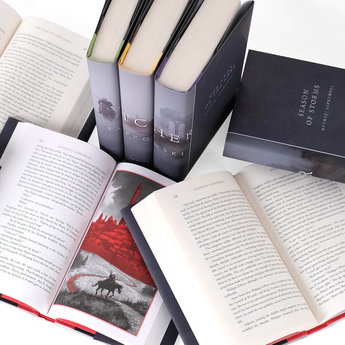 Close up of open book to display font size in The Witcher Series. Open books surrounded by other books in the series.