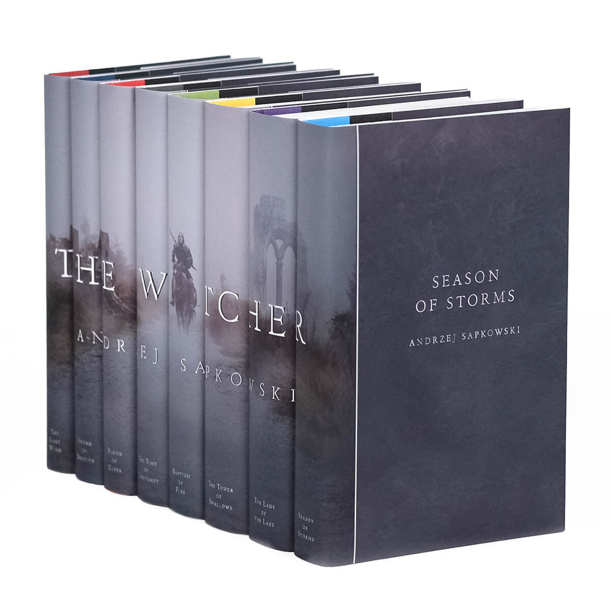 The Witcher custom collectible dust jackets from Juniper Custom featuring an image of a man on a horse walking on a path through the mist across the book spines.