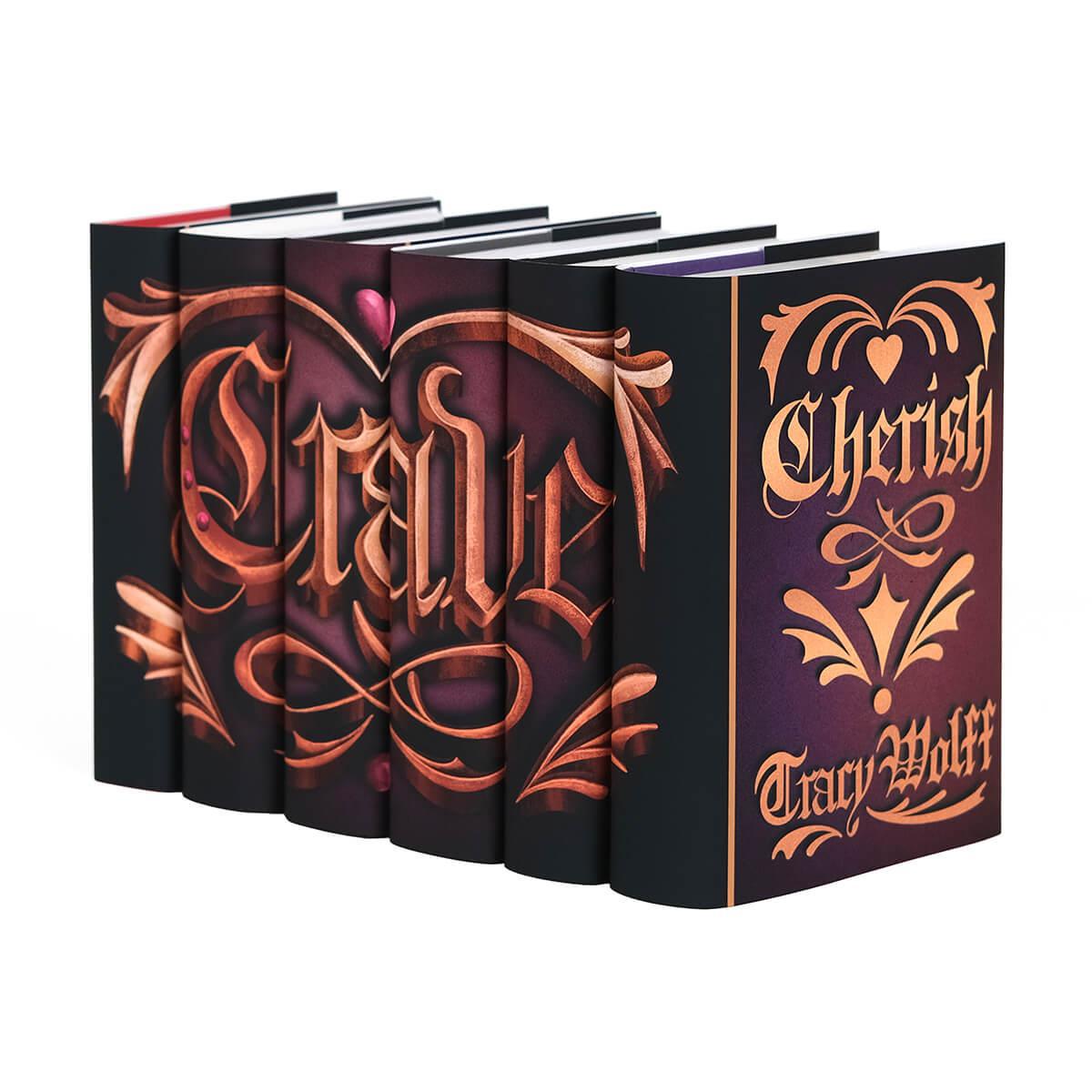 Side angle shot of the Crave Series by Tracy Wolff. Bronze ornamental gothic illustration of the word "Crave". Illustration set against a pink to black gradients surrounded by embossed style ornaments and a pink heart centered across the spines.