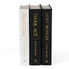 Unjacketed spines for Iron Gold, Dark Age, and Light Bringer by Pierce Brown. The spines for Iron Gold is white, and the other two books are black. Spines display book title, author name, and publisher in gold foil. 