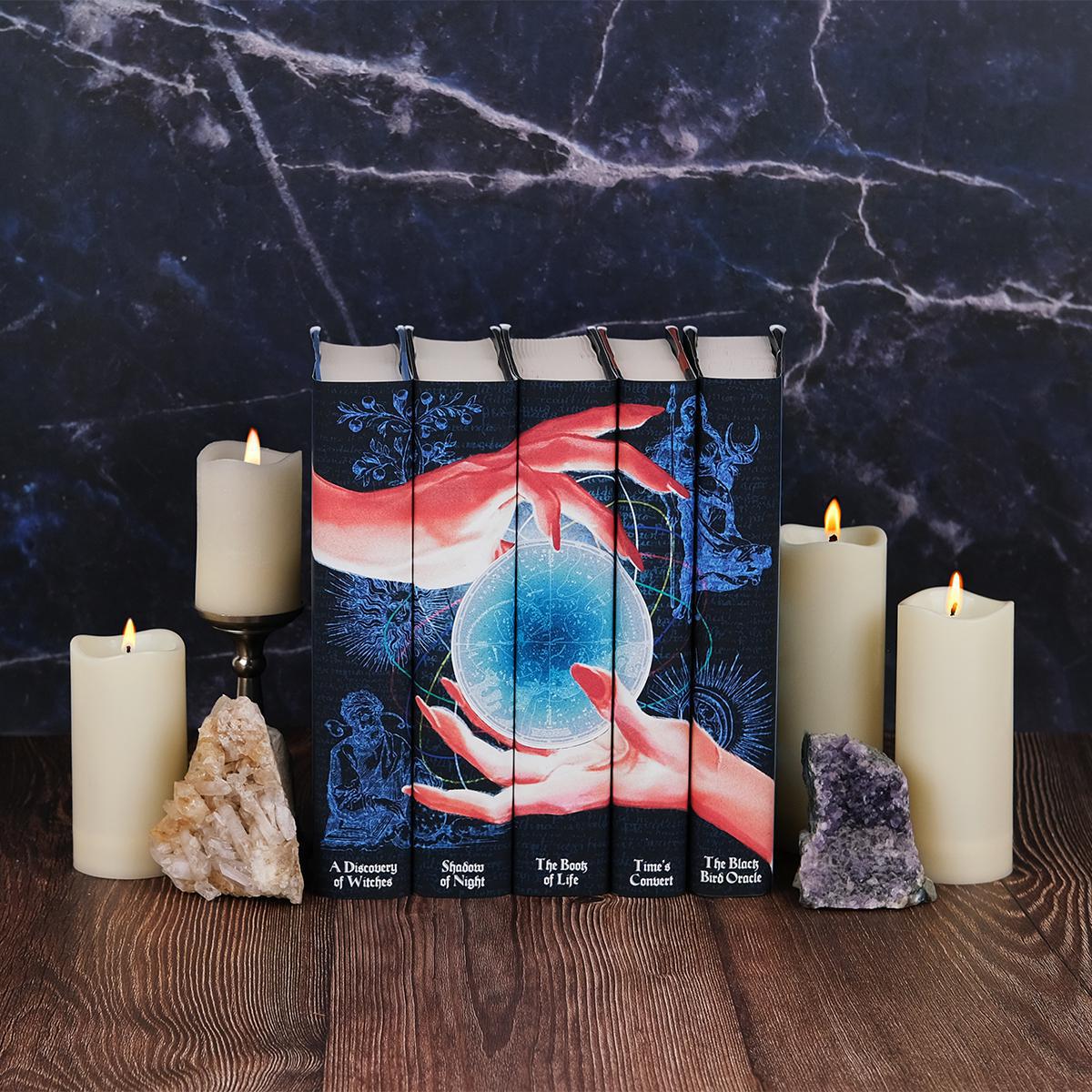 Install shot of All Souls Series sitting on wood surrounded by lit candles and crystals set against a blue marble background