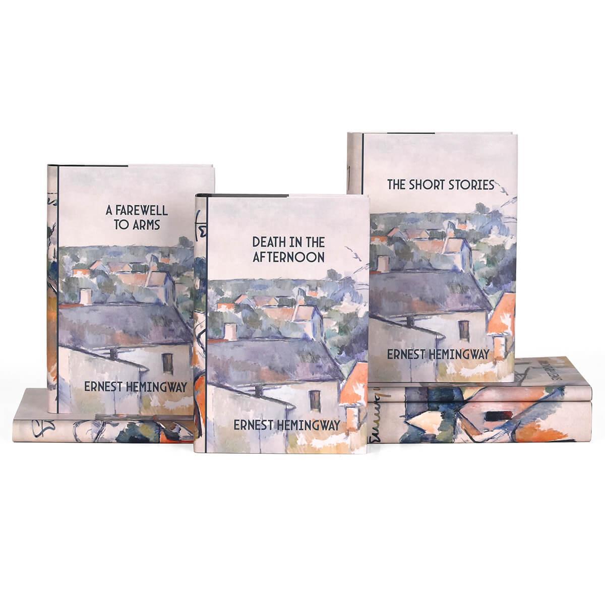 Front covers of the Ernest Hemingway set from Juniper Books. Covers feature book title and author and a portion of the painting "Rooftops" by Paul Cézanne.