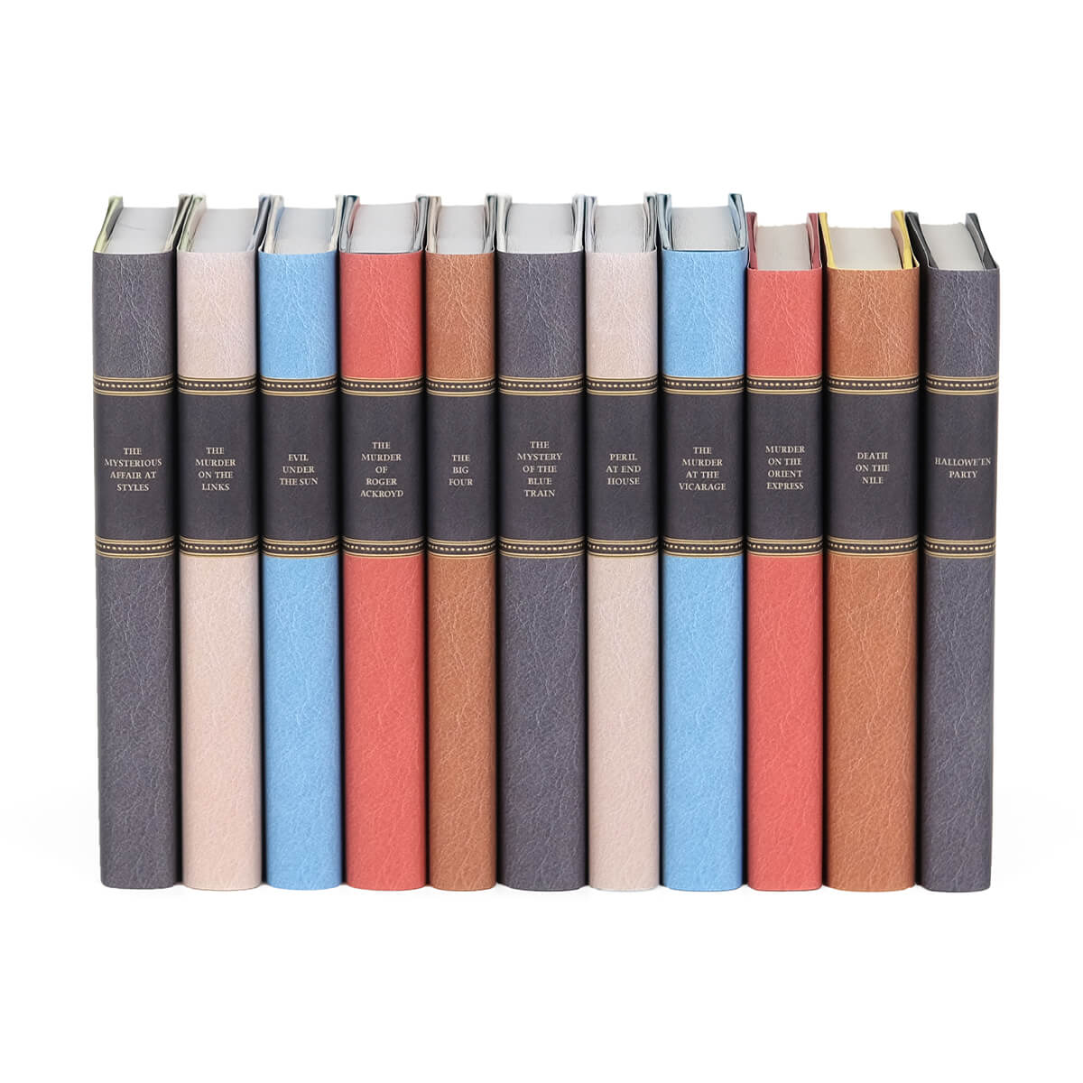 Agatha Christie books wrapped in custom collectible faux leather dust jackets  in black, beige, blue, red, light brown from Juniper Custom. Book spines feature book titles typed in gold color serif font set against back faux leather.