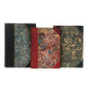 This image showcases three antique books with striking marbled covers and leather bindings on a blank white background. Each book features a unique marbled pattern in shades of blue, red, and green, complemented by gold detailing. The spines are bound in high-quality leather emphasizing their vintage craftsmanship. These books exemplify classic bookbinding techniques, making them both visually appealing and historically significant.