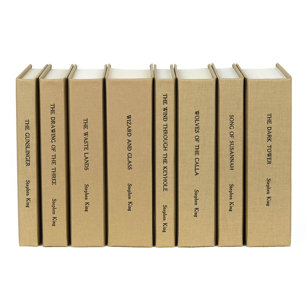 Unjacketed beige spines in The Dark Tower custom collectible set from Juniper Custom. Title and author name typed down spine in black font.