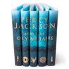 Percy Jackson and the Olympians type across five dust jackets in gold serif type. Blue covers with a dark blue wave patterns and gold symbols on each spine.