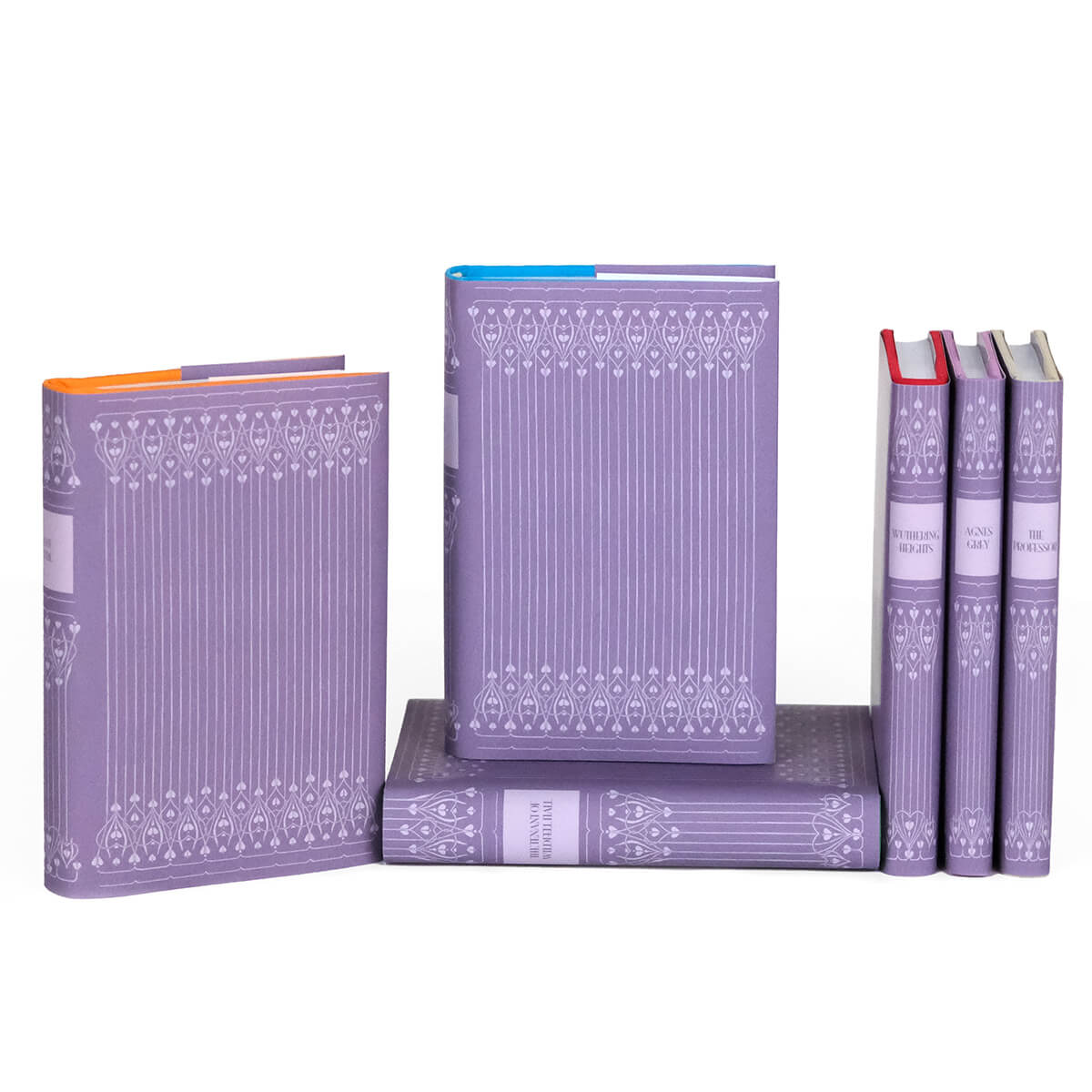 Custom collectible purple dust jackets with ornamental spines designs and book titles. Covers feature an intricate ornamental design in light purple on a darker purple background.
