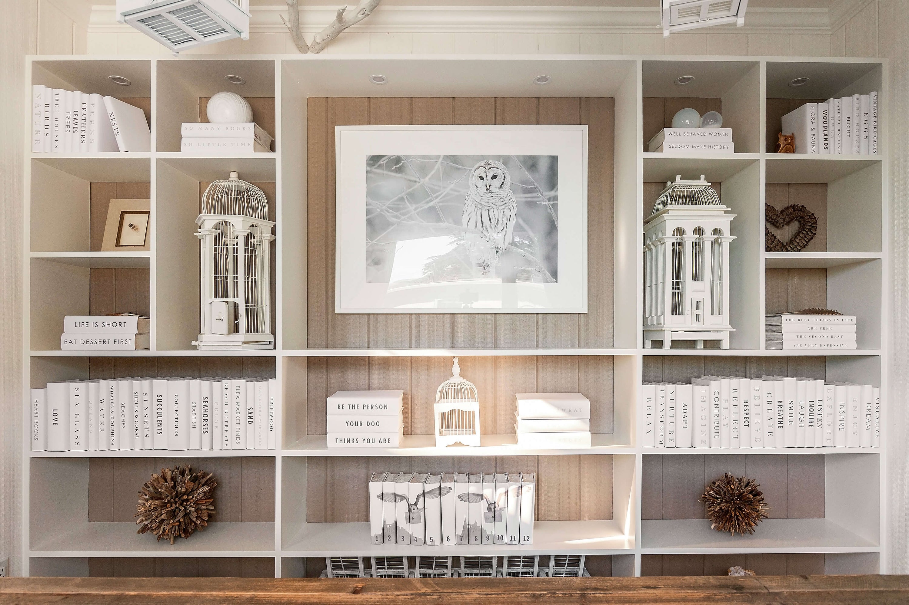 Some of our beachside projects are shown here, but the possibilities are endless. We have frequently taken a minimalistic approach to beach house book collections by crafting a series of pristine white book jackets
