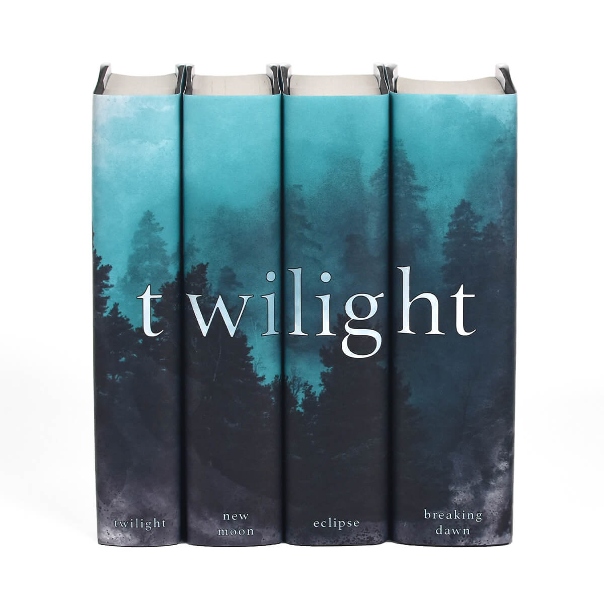 Twilight Saga four book set from Juniper Custom. Twilight typed across spines in white serif font set against a blue and gray watercolor style foggy pine forest. Book title centered at the bottom of each spine.