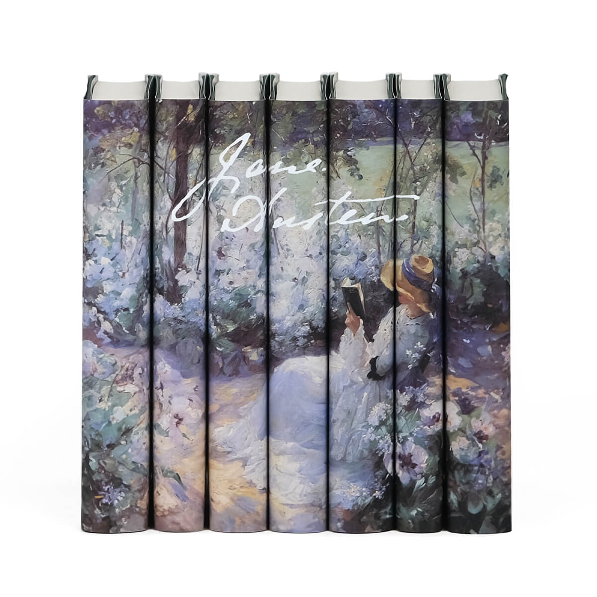 Jane Austen Book Set from Juniper Custom. Dust jackets featuring a Frank Bramley painting of a women reading in a garden across the spines and Jane Austen signature in white.