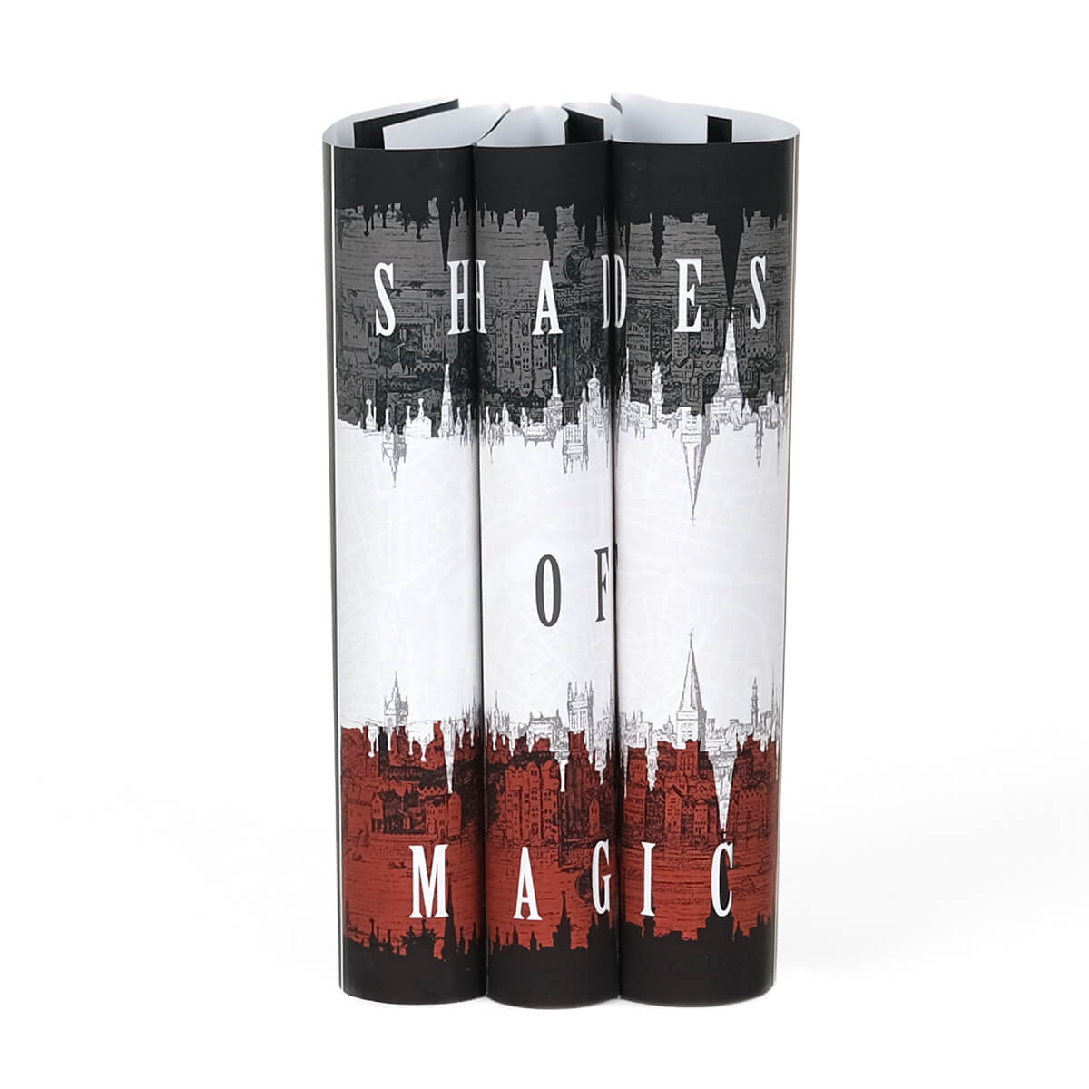 Dust Jackets Only feature a black, grey, white, and red city layered against a white map background. Shades of Magic typed across spines in white serif font.