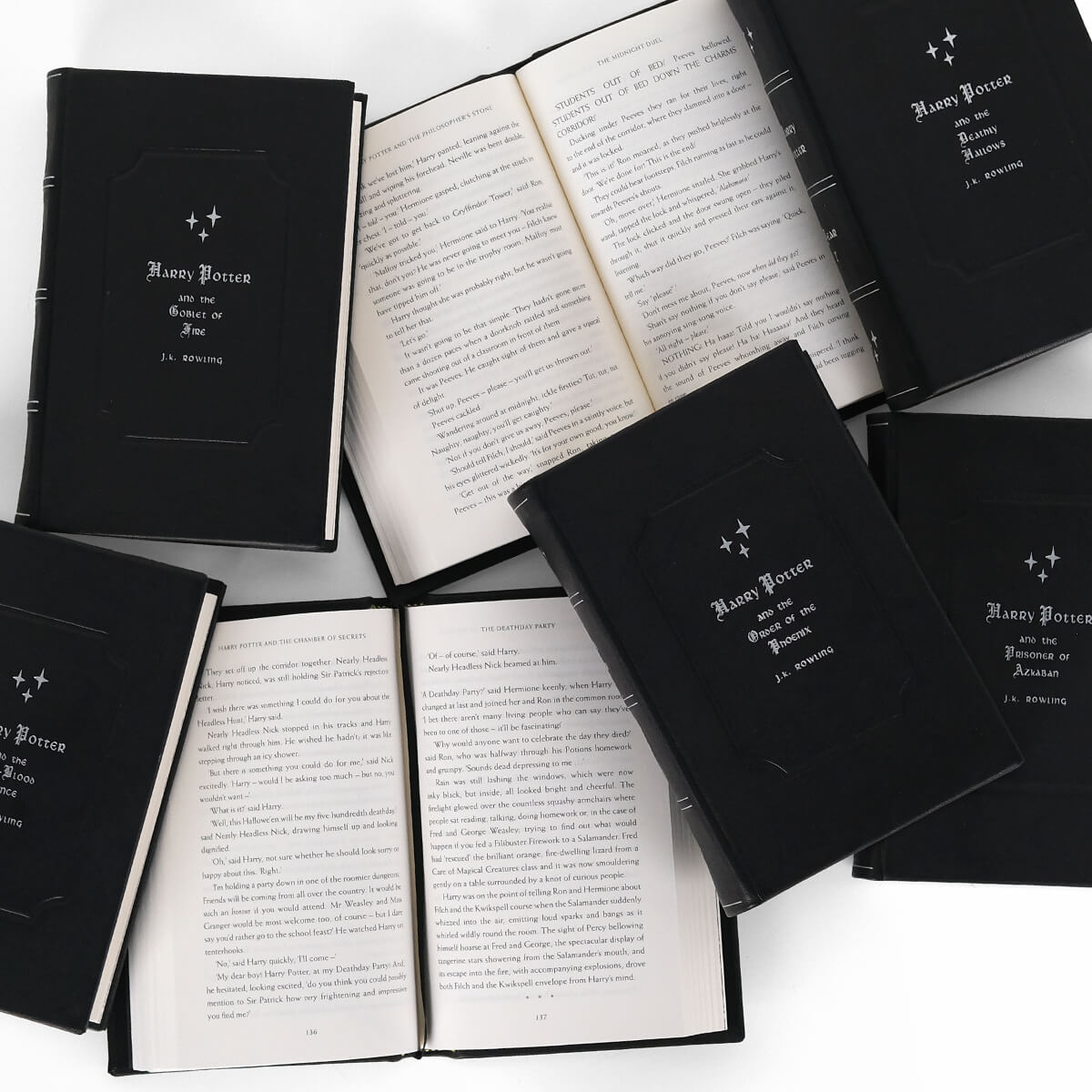 Print size for genuine black leather Harry Potter from Juniper Books. Front cover features book titles and author name in silver gothic font.