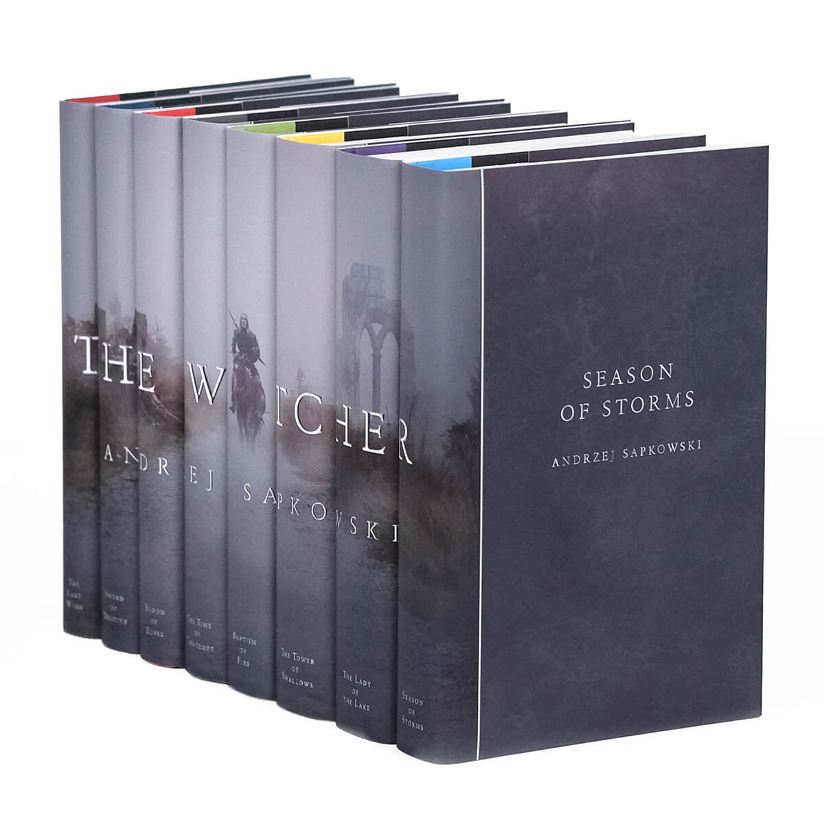 The Witcher custom collectible dust jackets from Juniper Custom featuring an image of a man on a horse walking on a path through the mist across the book spines. 