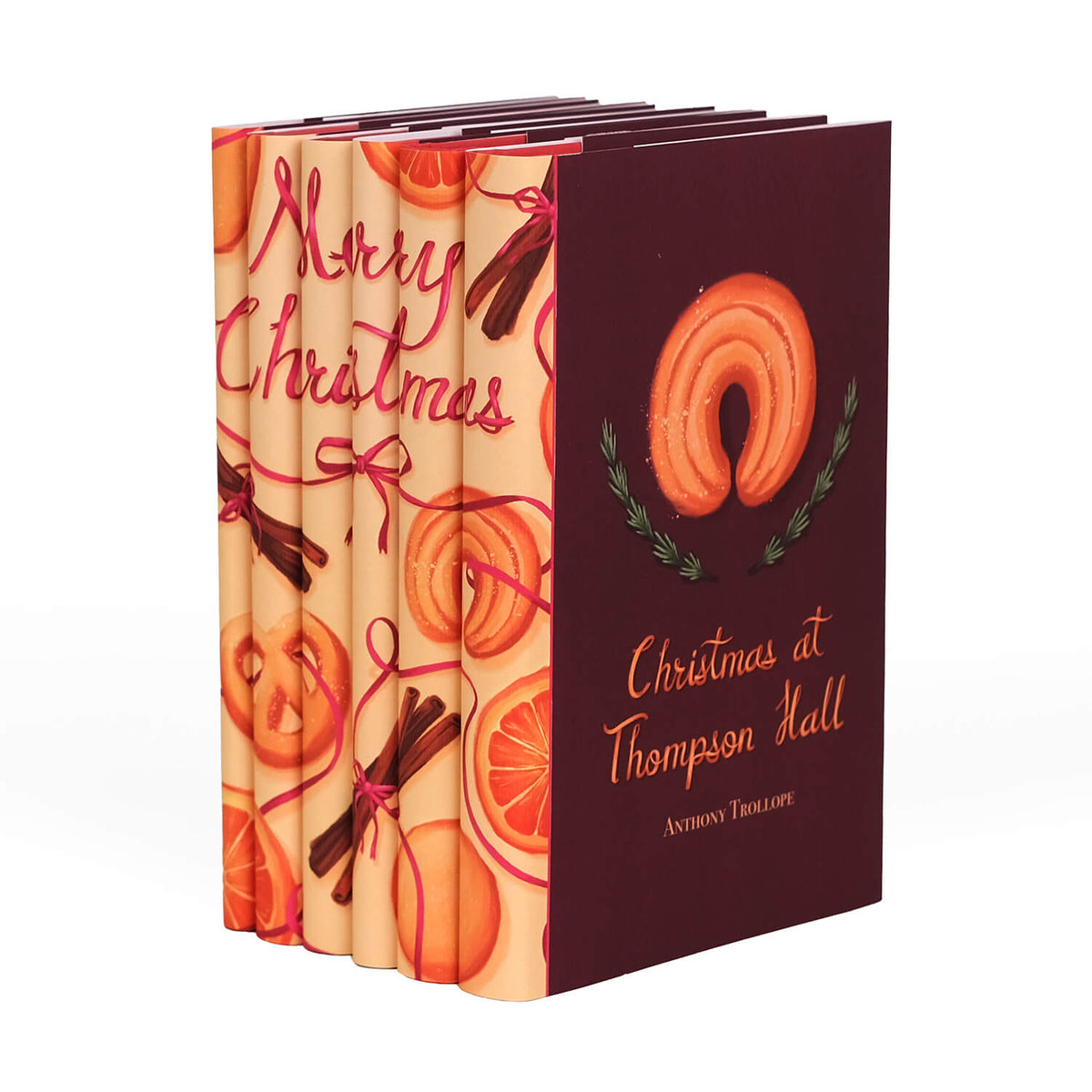 Angled view displaying spine and cover design of Christmas Classics 2025 Book Set wrapped in Juniper Books collectible book covers.
