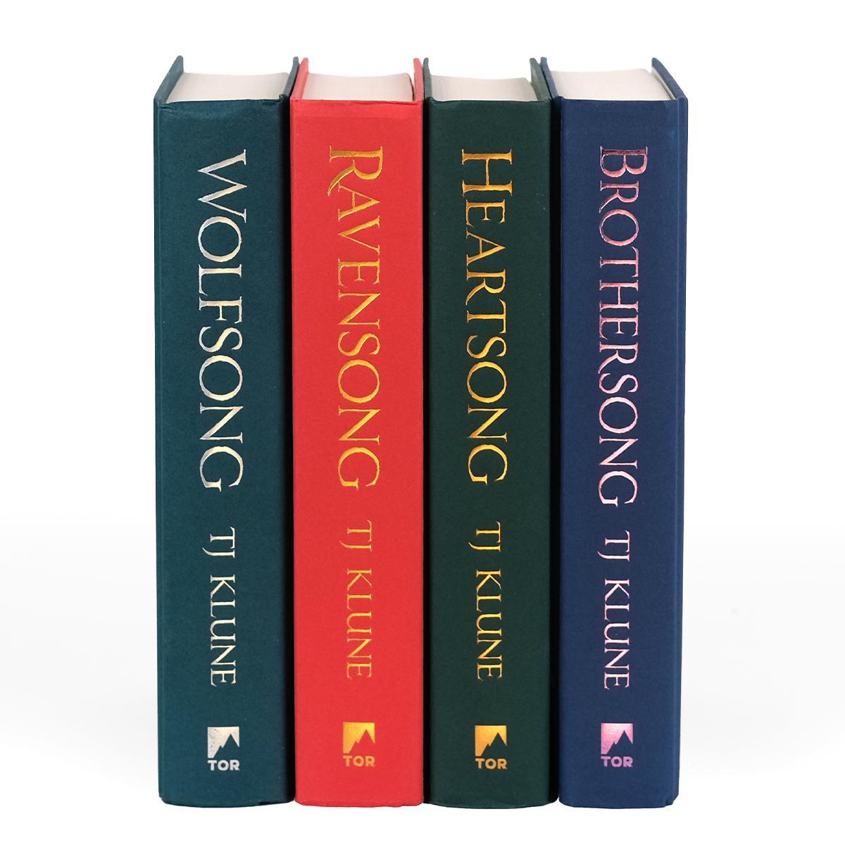 Four hardcover books from TJ Klune's Green Creek series are standing upright side by side, showing their spines. The titles, from left to right, are Wolfsong, Ravensong, Heartsong, and Brothersong. Each spine has a unique color—dark green, red, dark teal, and navy blue—with the titles and author's name in gold or silver foil lettering, and the Tor logo at the bottom.