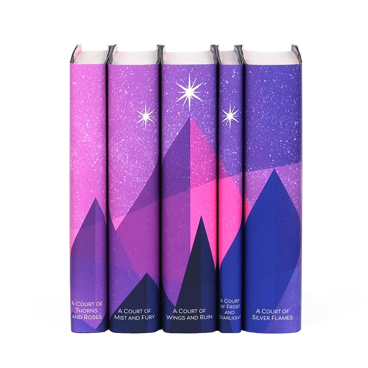 Sarah J Maas Universe Book Set from Juniper Books. A pink and purple mountain range spans book spines set against a starry sky.