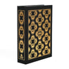 The black dust jacket box by Juniper Books, resembling a hardcover book spines. The box features intricate, symmetrical patterns in metallic colors on the spine and covers—gold on a black box. The Juniper Books logo is displayed at the bottom of each spine.