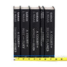 Unjacketed photo of the A Court of Thorns and Roses Series by Sarah J. Maas. Books are black with silver type on the spine detailing book title and author. Tape measure rests against base of spines to show set width.