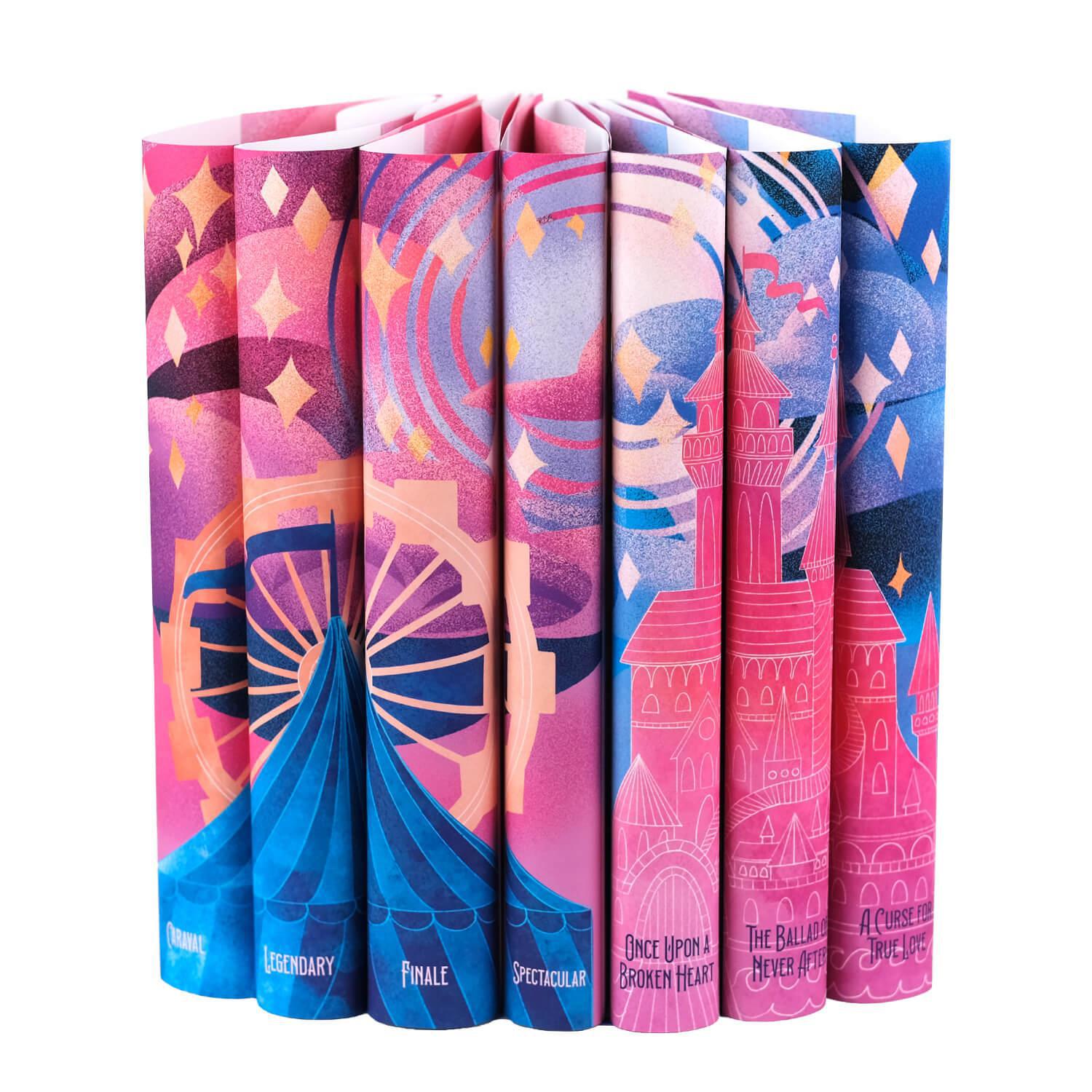 A set of five book jackets arranged side by side to form a continuous illustration of a carousel, a castle, a circus tent, and pale yellow stars set against a pink, purple, and blue sunset. The spines of the books have the book titles in white and blue.